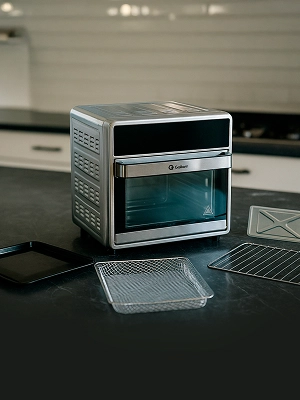 Imagem ilustrativa de um forno digital aberto em cima de uma mesa